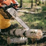 photo of person using chainsaw